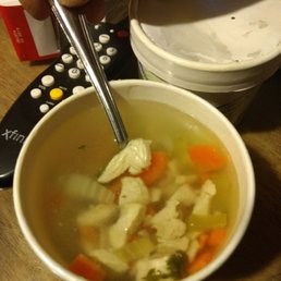 a bowl of soup and a remote control