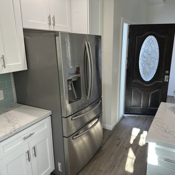 J and S Cabinet Services - a kitchen with stainless steel appliances - General Contractors Near Me
