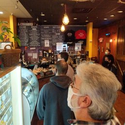 customers at the counter of a bakery customers at the counter of a bakery