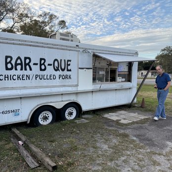 C&J Bar-B-Que - shows a man standing in front of a food truck - Southern Near Me - Largo, Florida