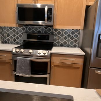 Lightning Remodel - a kitchen with stainless steel appliances - Flooring Near Me Lightning Remodel - a kitchen with stainless steel appliances - Flooring Near Me