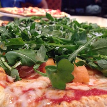 Brixx Wood Fired Pizza + Craft Bar - Pizza with arugula and melon and prosciutto - Pizza Near Me - Cary, North Carolina Brixx Wood Fired Pizza + Craft Bar - Pizza with arugula and melon and prosciutto - Pizza Near Me - Cary, North Carolina