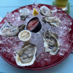 Dirty Oysters. (Fresh hand-shucked oysters topped w/ caviar, sour cream, & red onion.)