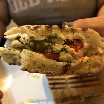 Zio's Pizzeria - a person holding a sandwich - Pizza Near Me - Allentown, Pennsylvania Zio's Pizzeria - a person holding a sandwich - Pizza Near Me - Allentown, Pennsylvania
