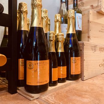 The Corner Store, Downtown Naples - a row of bottles of champagne - Wine Tasting Room Near Me - Naples, Florida The Corner Store, Downtown Naples - a row of bottles of champagne - Wine Tasting Room Near Me - Naples, Florida