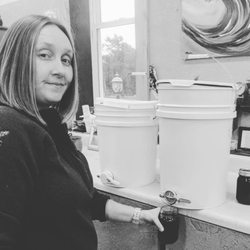 Summer Smiles Honey - Amanda bottling honey.