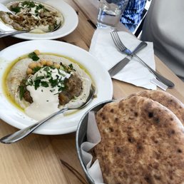 three plates of food on a wooden table