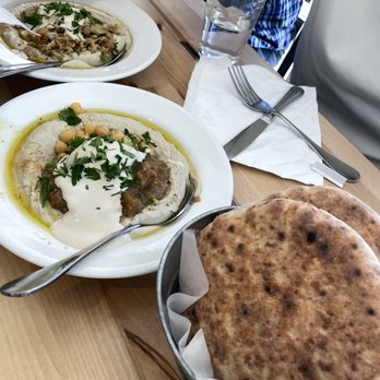 Hummus Elite - three plates of food on a wooden table - Mediterranean Near Me - Englewood, New Jersey