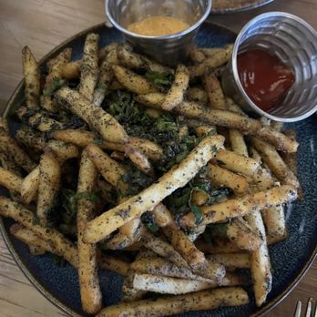 Space Cowboy - Farm House Garlic fries, parmesan, space ash thyme & kaffir lime with chipotle aioli, truffle oil.  OMGOODNESS!!!!!! - Cocktail Bars Near Me - Austin, Texas