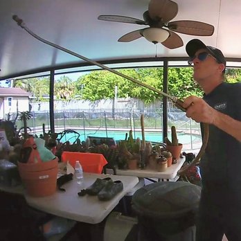 Chet's Termite & Pest Management - Spraying anti-termite liquid around the windows and the door at the Lanai. - Pest Control Near Me - Tampa, Florida