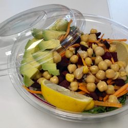 The Health Bar - Joyful Greens and Grains Salad with fresh lemon wedge and avocado.
