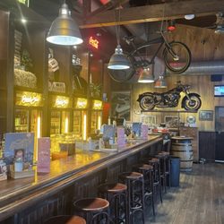 Road Stop - The long wooden bar with a row of stools