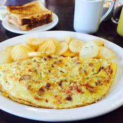 The Speak Easy Cafe - Meat Lovers omelette with Toast, potato coins and coffee included for $8.99!!! Orange juice too!!