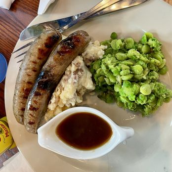 Lost Colony Tavern - Bangers & Mash - 2 Irish style pork sausages (char grilled fer real) - mushy peas, mashed potatoes, bistro gravy - $16 - Pubs Near Me - Manteo, North Carolina