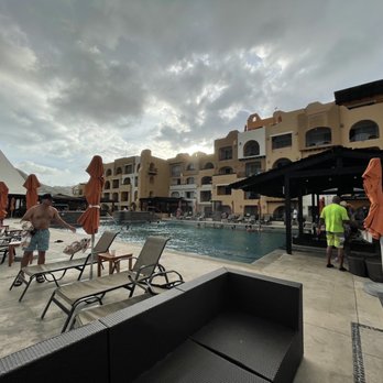 Tesoro Los Cabos - poolside bar and deck + rooftop restaurant in background, ft. incoming storm - Hotels Near Me - Cabo San Lucas, BCS
