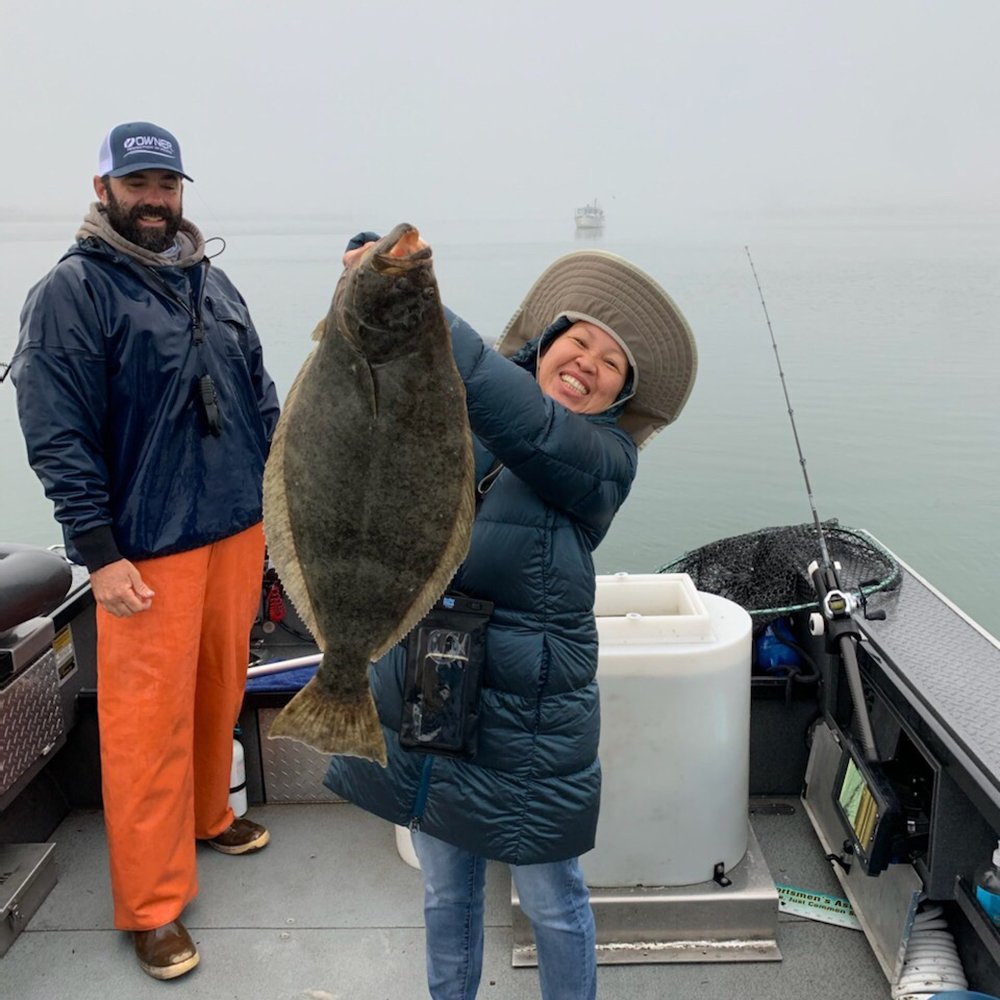 Redwood Coast Fishing - Guide Mike watches Sumalee hold up her catch. - Fishing Near Me - Eureka, California Redwood Coast Fishing - Guide Mike watches Sumalee hold up her catch. - Fishing Near Me - Eureka, California
