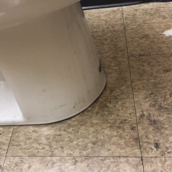 Firestone Complete Auto Care - Caked on firth and dirt all over this bathroom. Looks like they don't even mop it. This is LONG TERM buildup. - Tires Near Me - Montclair, California