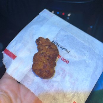 Cook Out - a hand holding a piece of food - Burgers Near Me - Marietta, Georgia