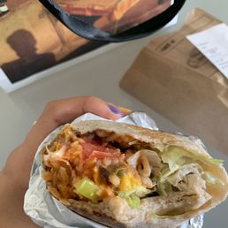 a hand holding a burrito a hand holding a burrito