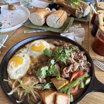 Pho Kitchen - Bò Né ( sizzling steak with eggs, pate, and veggies. Comes with yummy bread for dipping) - Vietnamese Near Me - Morrisville, North Carolina Pho Kitchen - Bò Né ( sizzling steak with eggs, pate, and veggies. Comes with yummy bread for dipping) - Vietnamese Near Me - Morrisville, North Carolina