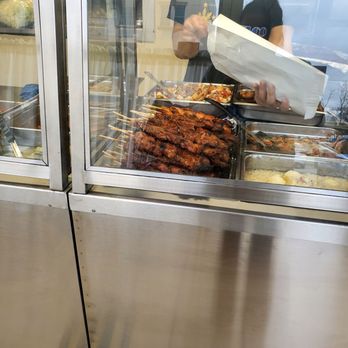 Guiradelco - a woman serving food in a restaurant - Filipino Near Me - Westbury, New York Guiradelco - a woman serving food in a restaurant - Filipino Near Me - Westbury, New York