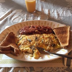 Cabreras Pizzeria & Restaurant - A mushroom, provolone omelette with a side of corned beef has accompanied by some whole wheat toast. Glass of oj to wash it all down.
