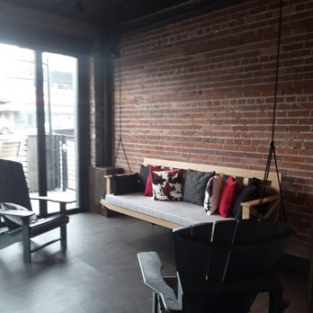 The Cabin Pub + Party - a swing chair and a couch - Pubs Near Me - Edmonton, Alberta