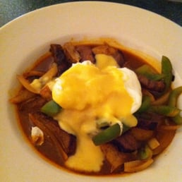 a plate of food with eggs on top a plate of food with eggs on top