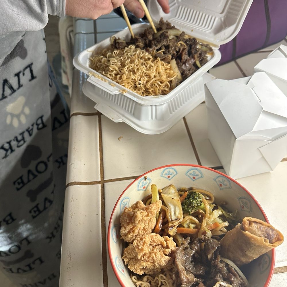 Lemongrass chow fun overflowing and underneath veggie chow mein, also overflowing. With fried shrimp and egg roll in the bowl. Lemongrass chow fun overflowing and underneath veggie chow mein, also overflowing. With fried shrimp and egg roll in the bowl.