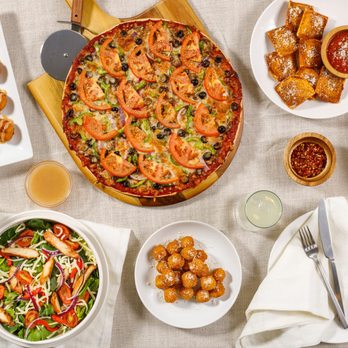 Imo's Pizza - a variety of food on a table - Pizza Near Me - Saint Louis, Missouri Imo's Pizza - a variety of food on a table - Pizza Near Me - Saint Louis, Missouri