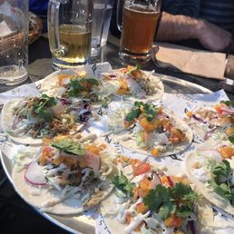 a platter of tacos and beer