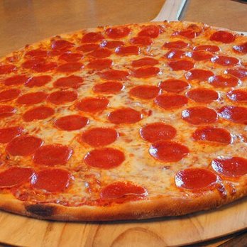 Legend Pizza - a pepperoni pizza on a cutting board - Pizza Near Me - Hamden, Connecticut