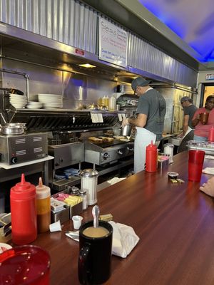 Photo of Stav's Diner - Columbus, OH, US. people in the kitchen preparing food