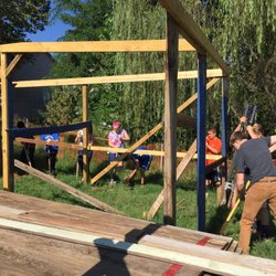 Community Montessori School - MMSK students getting practical life experience building a chicken coop