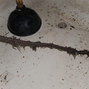 A&S Drain Cleaning - A dirty sink surface with a plunger and drain opening visible, alongside a drain snake covered in grime, hair, and debris, sh... - Plumbing Near Me - Levittown, Pennsylvania A&S Drain Cleaning - A dirty sink surface with a plunger and drain opening visible, alongside a drain snake covered in grime, hair, and debris, sh... - Plumbing Near Me - Levittown, Pennsylvania