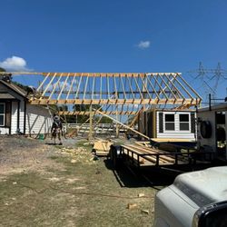 Atop of the Ladder - wooden roof frame being built