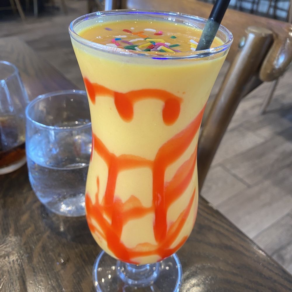 Yantra Kitchen - The Mango Lassi- cant dock points because it's a personal thing i think but the sprinkles made me not want to drink it haha - Indian Near Me - Artesia, California