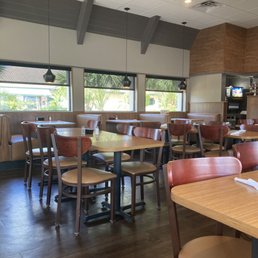 the inside of a restaurant with tables and chairs the inside of a restaurant with tables and chairs