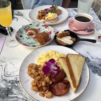 Sunny Side Cafe & Eatery - Any Style Eggs (front) and Smoked Salmon Benedict (back). Hash browns with Brie mid right in small skillet. - Breakfast & Brunch Near Me - Miami Beach, Florida Sunny Side Cafe & Eatery - Any Style Eggs (front) and Smoked Salmon Benedict (back). Hash browns with Brie mid right in small skillet. - Breakfast & Brunch Near Me - Miami Beach, Florida