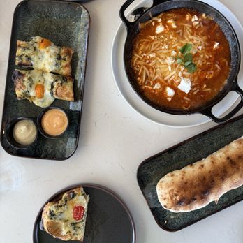 Rafaello Pizza & Coffee - Flat bread Shakshuka which is a Skillet with eggs & tomato sauce - Coffee & Tea Near Me - Houston, Texas Rafaello Pizza & Coffee - Flat bread Shakshuka which is a Skillet with eggs & tomato sauce - Coffee & Tea Near Me - Houston, Texas