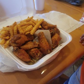 America's Best Wings - Honey lemon pepper wings left and jamaican jerk or the right with old bay sprinkled fries - Chicken Wings Near Me - Baltimore, Maryland