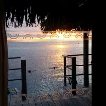 Travel Wizards - Our view from our bed in our over the water bungalow. We were also able to snorkel right off of our deck! - Travel Services Near Me Travel Wizards - Our view from our bed in our over the water bungalow. We were also able to snorkel right off of our deck! - Travel Services Near Me
