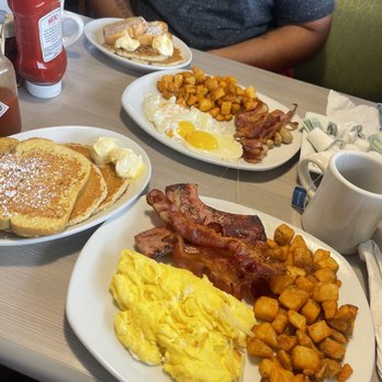 Perkins American Food - a man sitting at a table with breakfast foods - Bakeries Near Me - North Platte, Nebraska Perkins American Food - a man sitting at a table with breakfast foods - Bakeries Near Me - North Platte, Nebraska