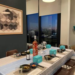 Tomokase - Dining setting in rooftop lounge of apartment