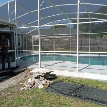 Elijah Praised - a man standing in front of a pool enclosure - Patio Coverings Near Me
