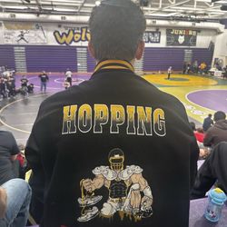 yours and mine SPORTS - The embroidery of the football player holding track cleats and a wrestling headpiece was completed by them!