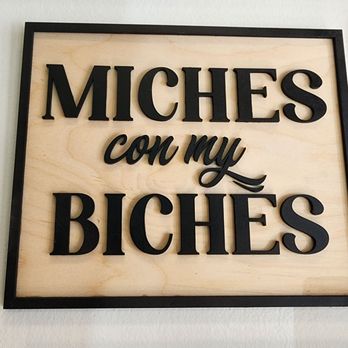 Mestiza - A square wall sign features the phrase "MICHES con mi BICHES" in black raised letters on a light wood background, framed with a black border. - Jewelry Near Me - Chicago, Illinois