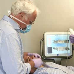 Xcelerated Orthodontics - Dr. Baker performs an Invisalign smile assessment using an iTero digital scanner.