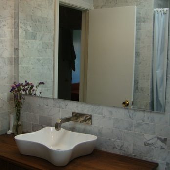 New Amsterdam Builders - a bathroom sink and mirror - General Contractors Near Me - Sunnyside, New York New Amsterdam Builders - a bathroom sink and mirror - General Contractors Near Me - Sunnyside, New York