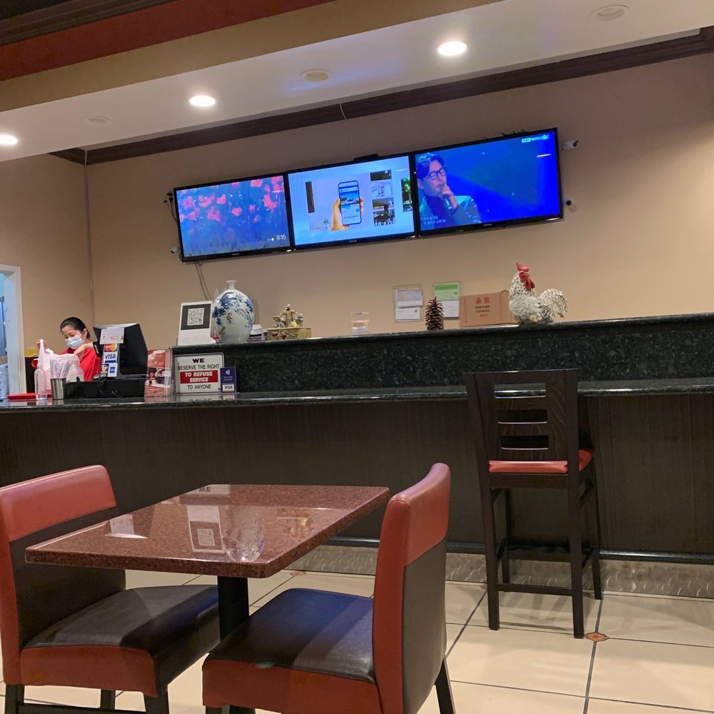 a view of a restaurant counter with a television